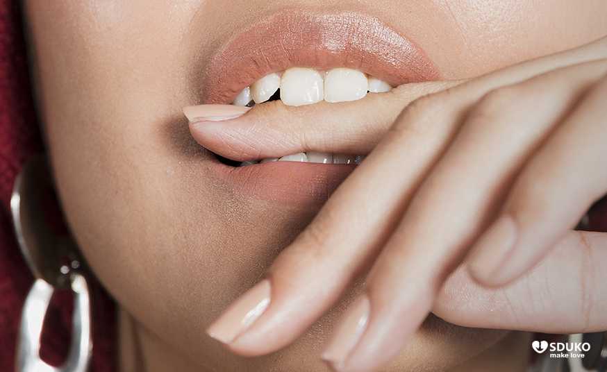Woman biting finger